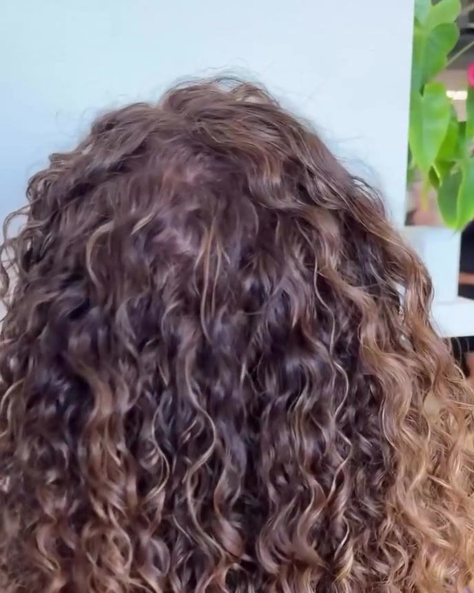 Long dimensional curls with soft gray coverage and warm highlights